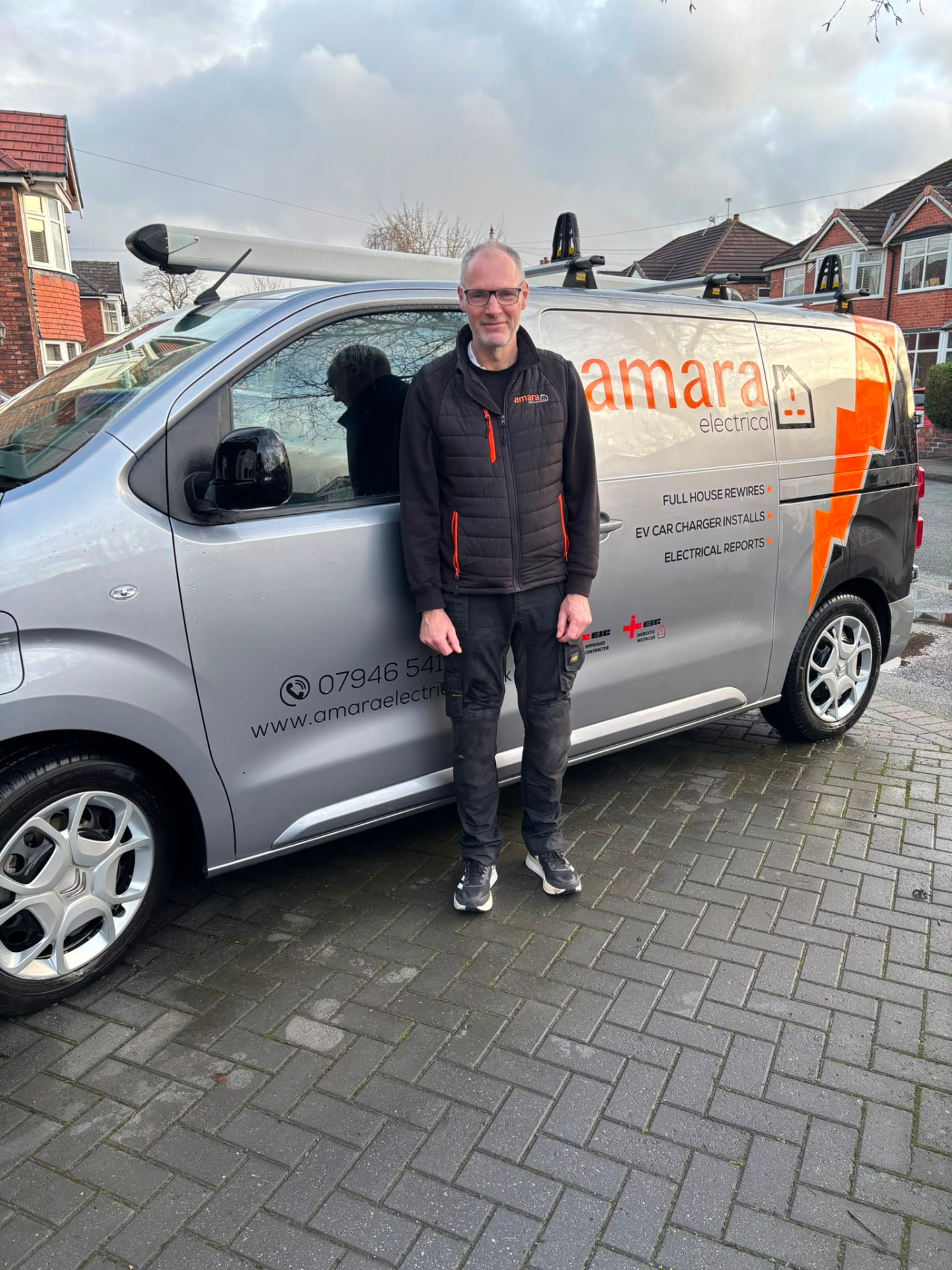 Mike Maccabe of Amara Electrical Contractors standing beside the branded company van